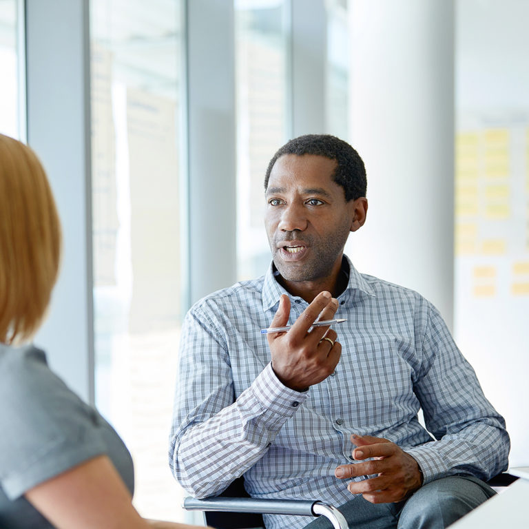Man Talking to Woman in Office Space