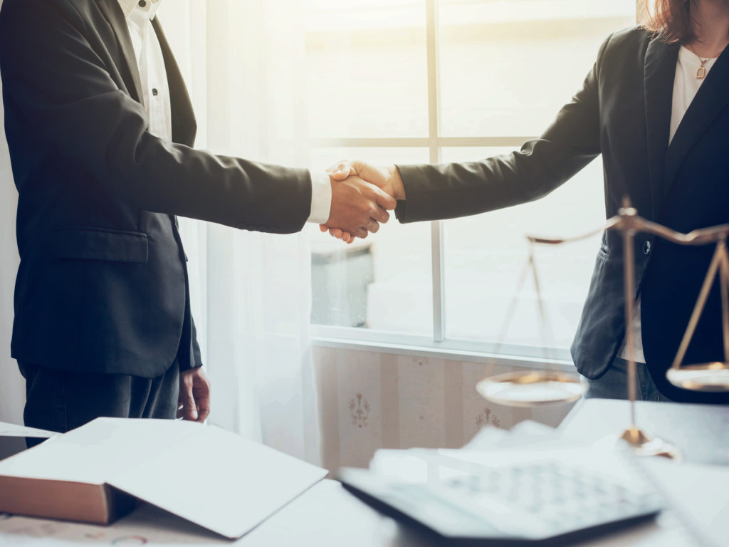 Businessman and lawyer shaking hands.