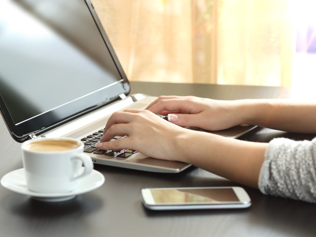 Lady hands typing in a laptop